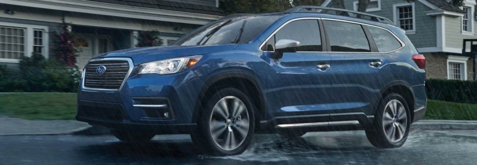 2019 Subaru Ascent driving through rainy neighborhood
